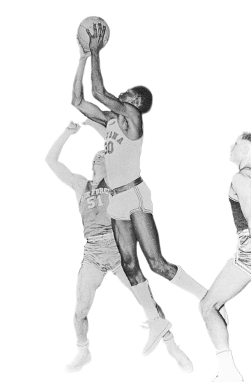 Ernie McCray, wearing University of Arizona jersey No. 30, takes a shot over an opposing defender during a basketball game.